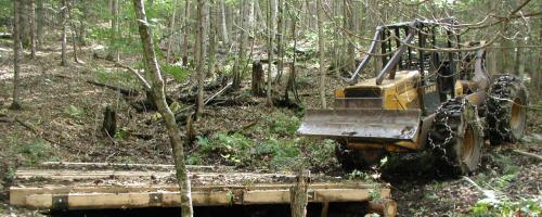 bulldozer going over bridge